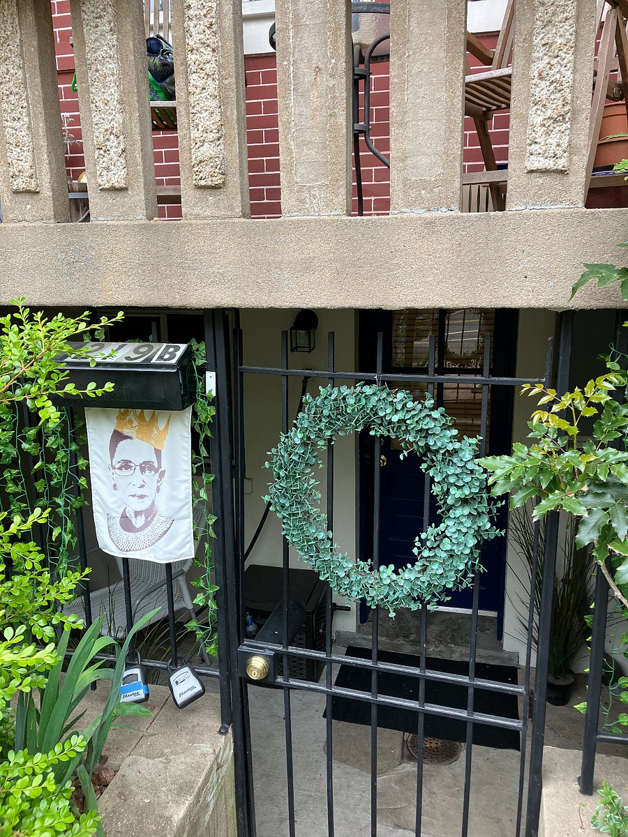 Apartment entrance: covered front patio, 3 steps down behind a locked gate. Can safely store bikes or strollers here.