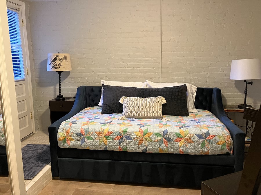 Bedroom 2: Daybed, twin trundle. Second bed pulls out from underneath. Room has a backdoor into the garden and a large closet with mirror to the left.