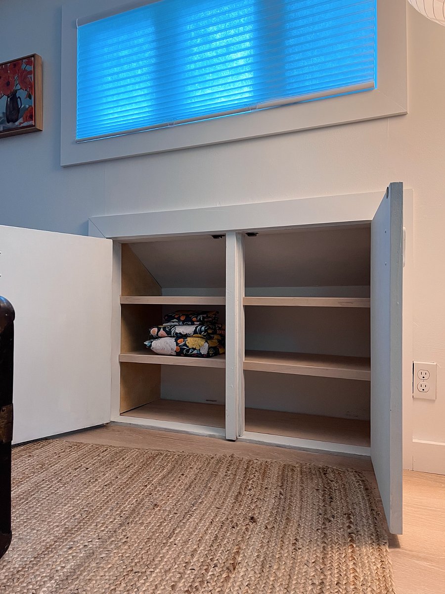 A built-in cupboard under the windows for storage. There is also an additional unfinished cupboard (not pictured) for additional storage.