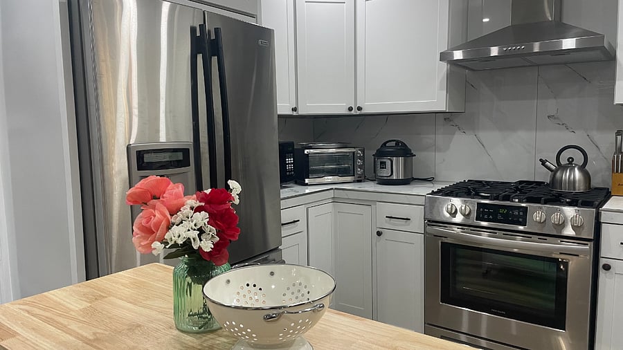 Fully stocked kitchen with appliances, dishes, spices, condiments