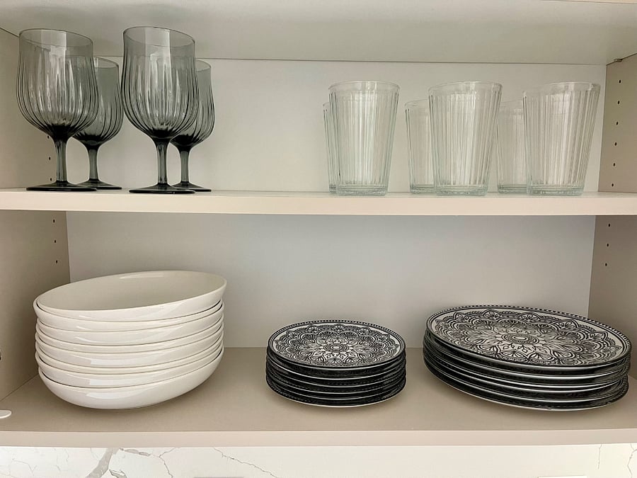 Kitchen has dishes and glassware