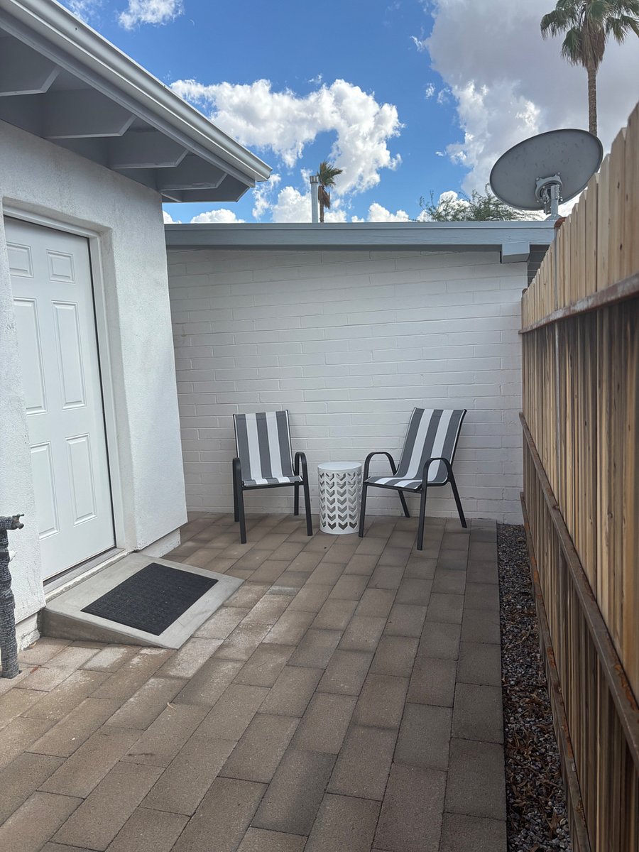 Secured front patio with chairs and table for morning coffee or evening relaxing