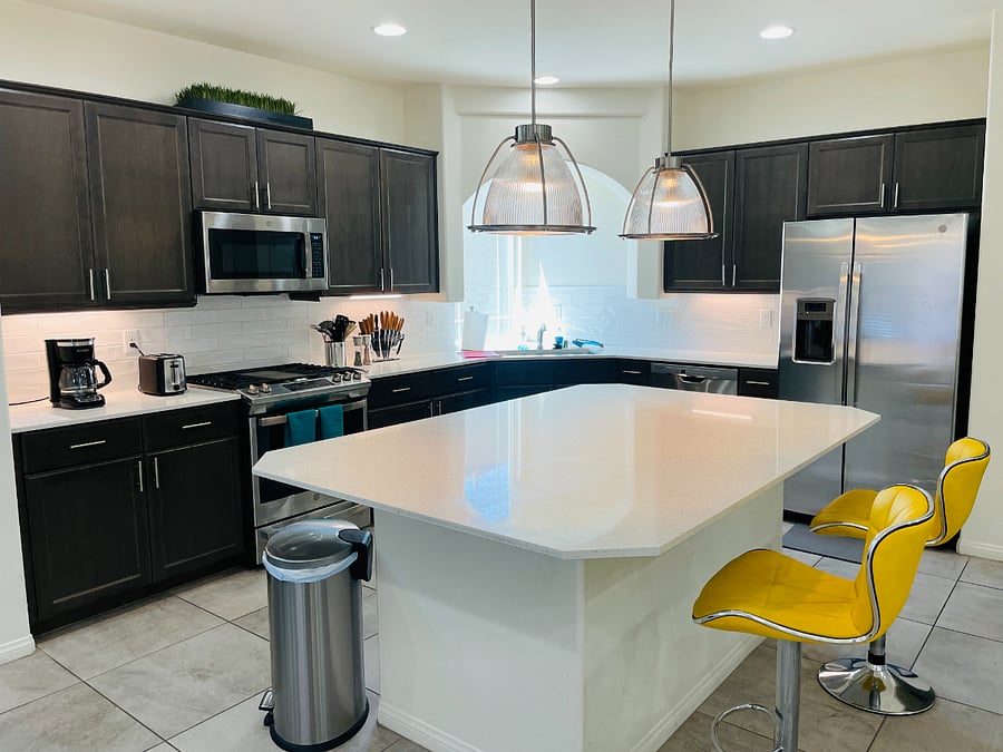 Modern kitchen with new stainless appliances and upgraded lighting
