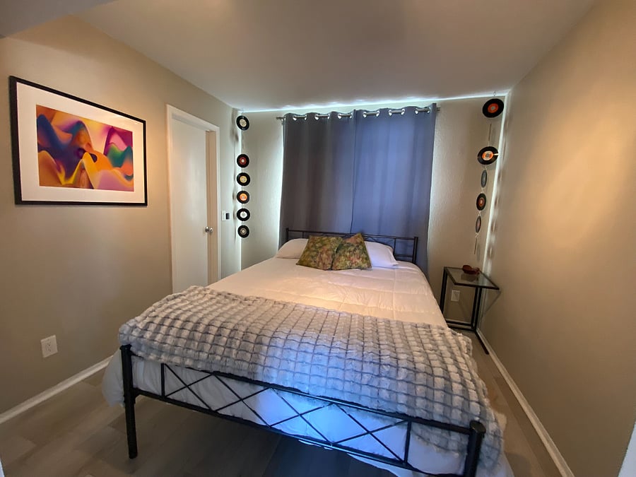 2nd bedroom with queen bed and black out curtains in all rooms.