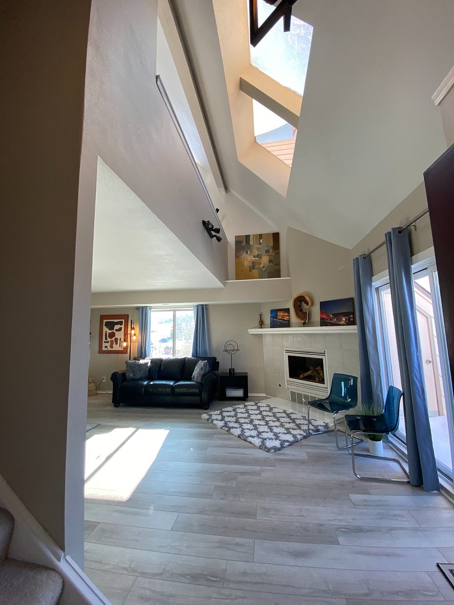 Entry view of living space, gas fireplace, sliding glass doors to balcony.  Mountain views!
