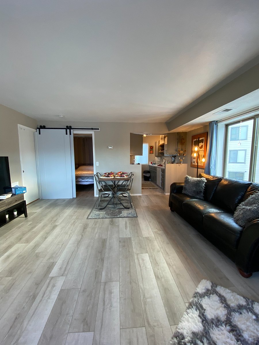 Living room, dining, downstairs bedroom with barn doors and kitchen.
