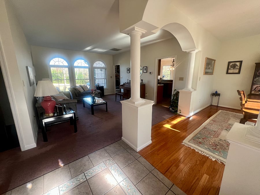 Looking into the house from the front door, the dining room is to the right the living room in front of you and the two doorways go into the kitchen and family rooms.