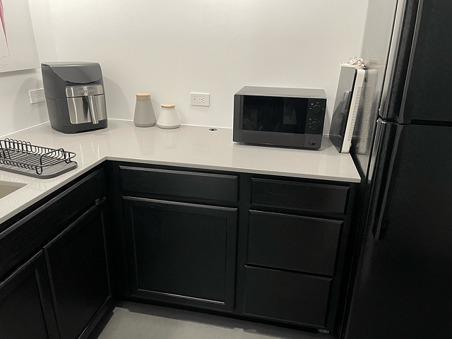 Cabinets for storage; all basic kitchen utensils; induction cooktop; microwave oven; air fryer with instructions (tutorial available upon request)