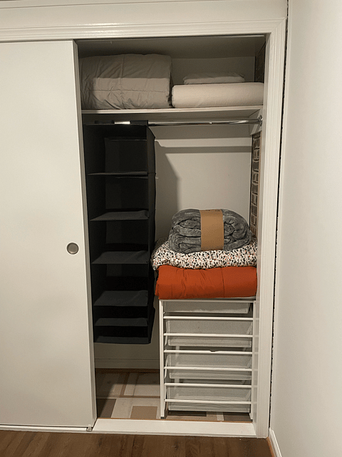Full-sized clothes closet with hanging shelves and metal Elfa drawers; plenty of fresh linens, including a variety of pillows to choose from