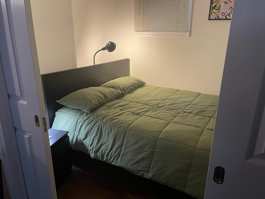 Sleeping area with sliding doors for privacy; reading lamp, nightstand light, and overhead lighting w/dimmer