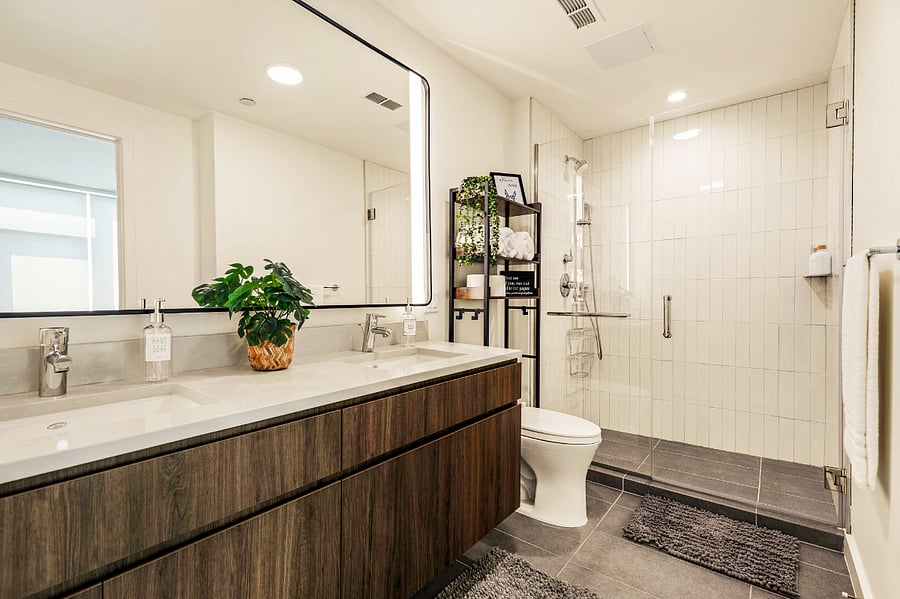 Unwind in this spa-inspired bathroom featuring a glass walk-in shower, double vanity, and warm, natural tones. Stocked with plush towels and boutique toiletries for your comfort.