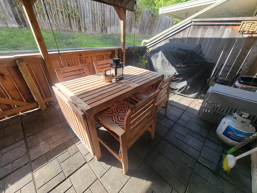 Outdoor patio; shades up and grill.