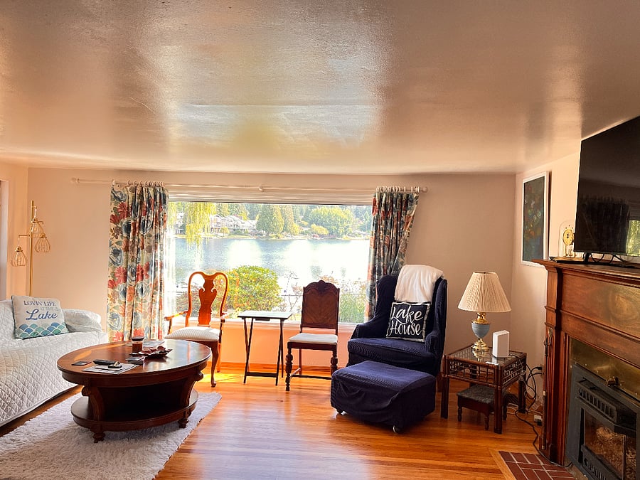 Main home, view from Baby Grand Piano wall towards picture window of Lake view and to Left full size couch and right is Gas Fireplace and 50" Samsung Smart TV above Fireplace