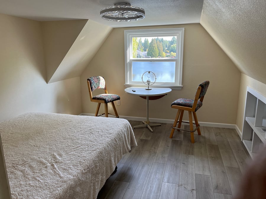 Main home, Upstairs Attic bedroom #3 with Queen bed, table/chairs, built in bookshelf and a walk in closet 
