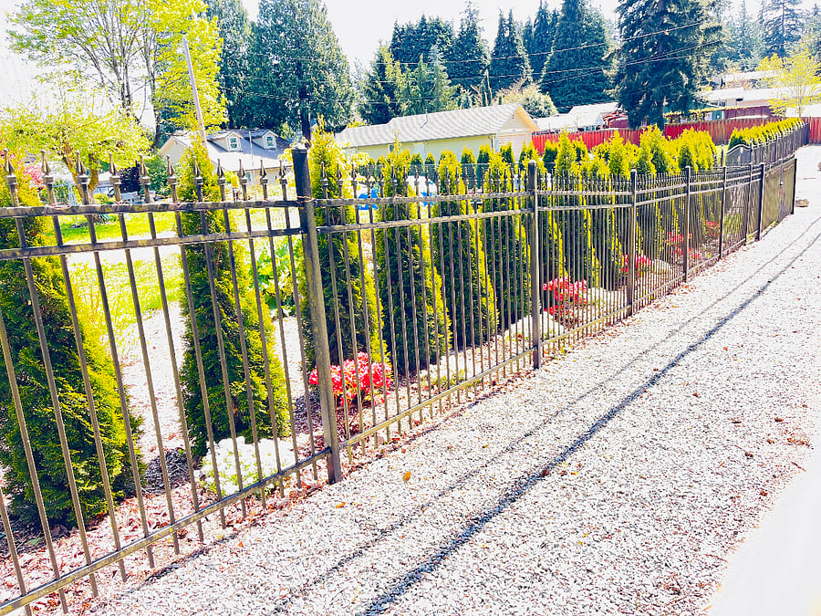 Main home & studio apartment 8th Ave SW street showing iron fencing with Automated Gate which is lit at night.