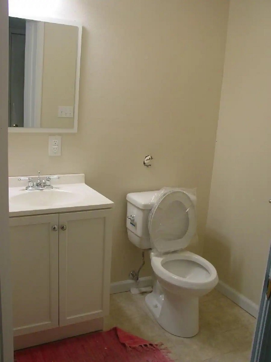 Half Bath off laundry room behind Second Bedroom.