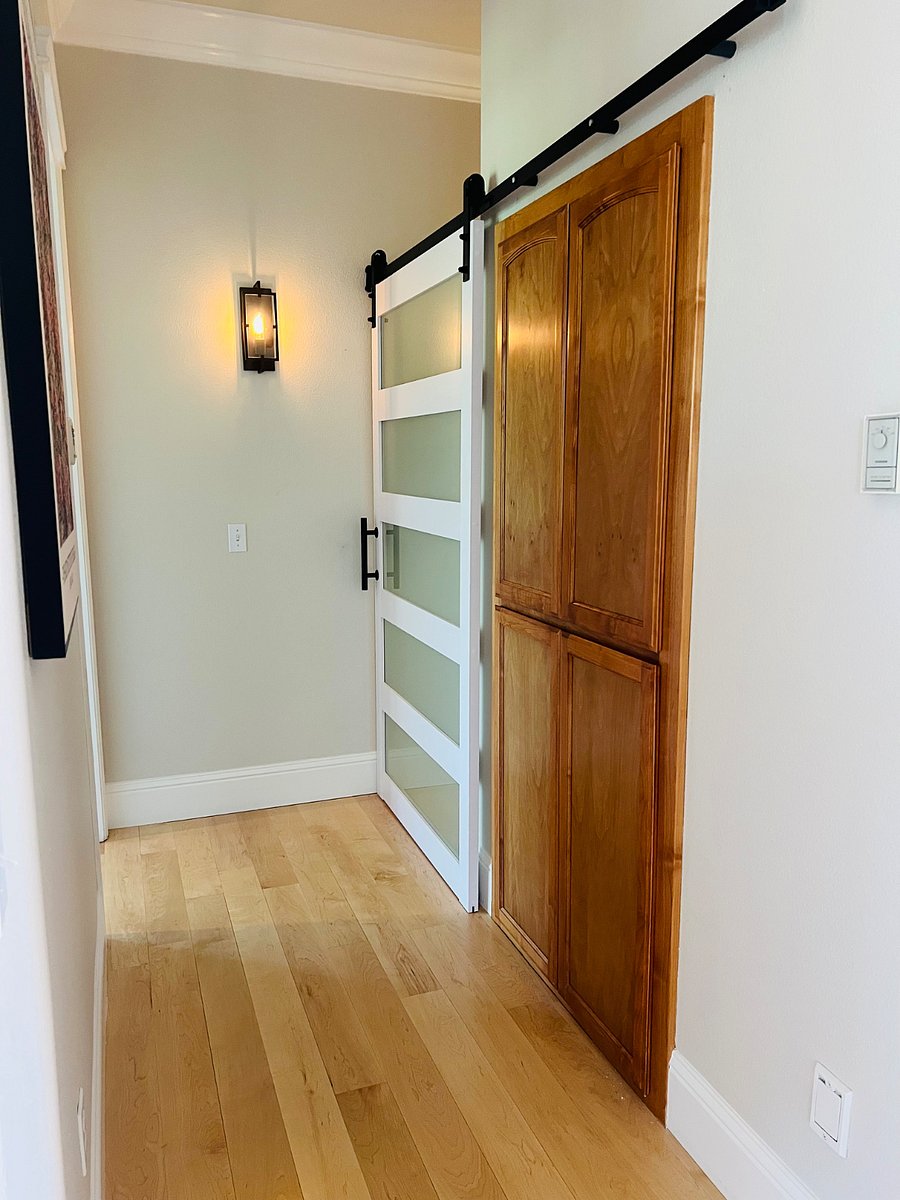Barn door closes off hallway and private bath 