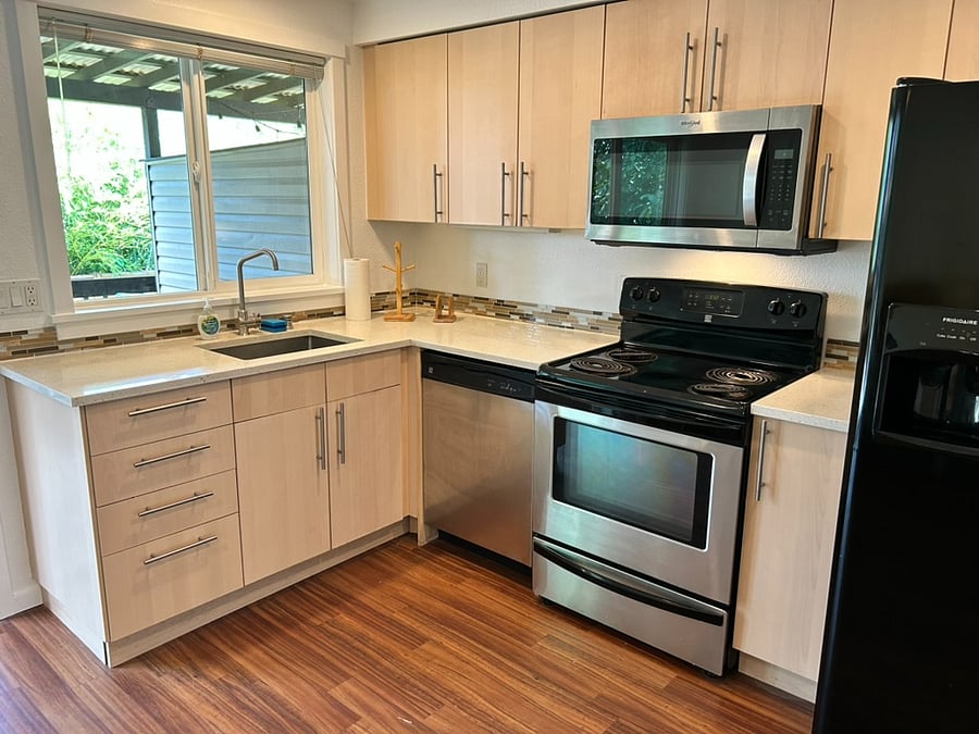 Cute full kitchen with dishwsher, stove, microwave.