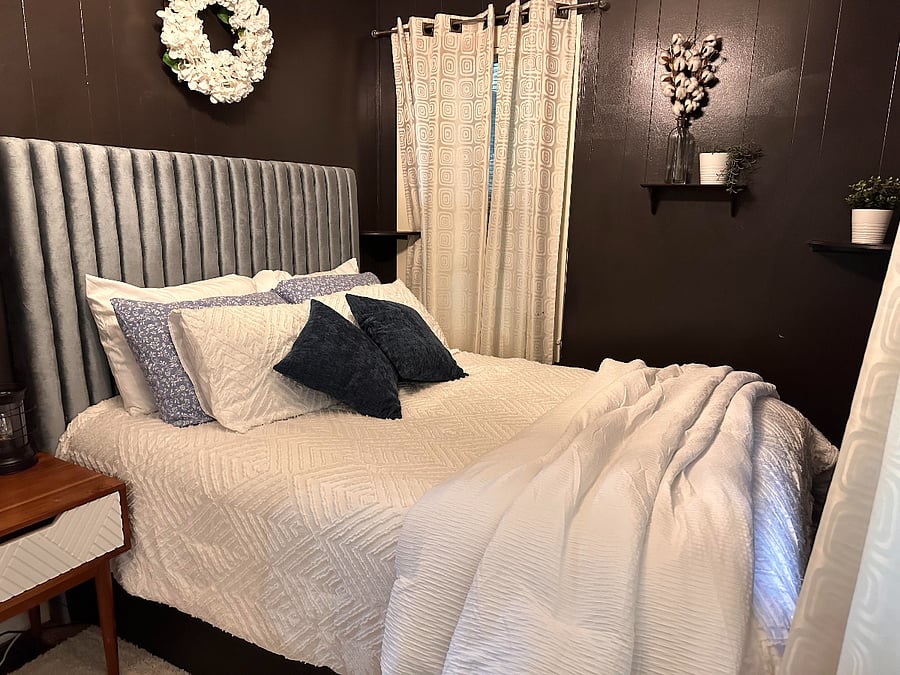 Primary bedroom with half bath is at the back of the home off of the kitchen. Queen sized bed