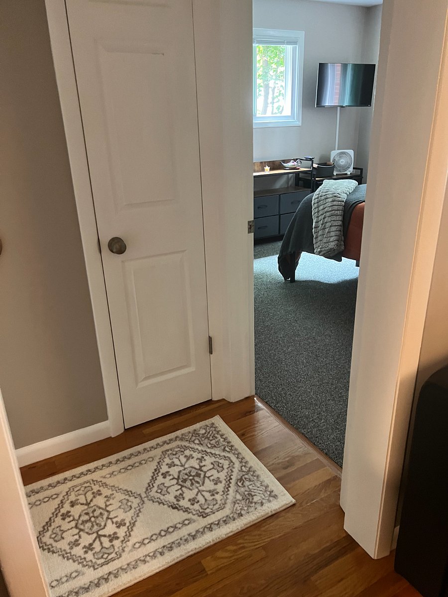 Entrance to larger front bedroom and hall closet for personal item storage.