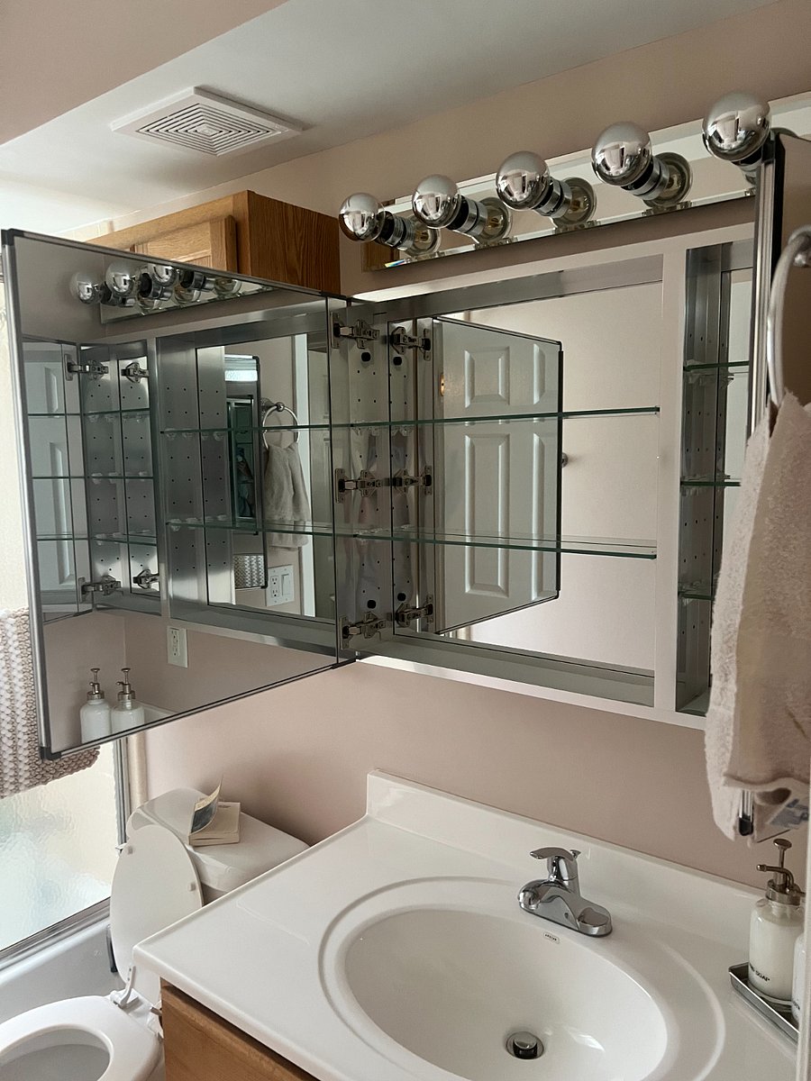 Mirrored medicine cabinet has lots of space for your personal items.