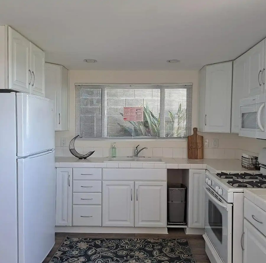 Full kitchen with range, over-the-counter microwave, full-size refrigerator