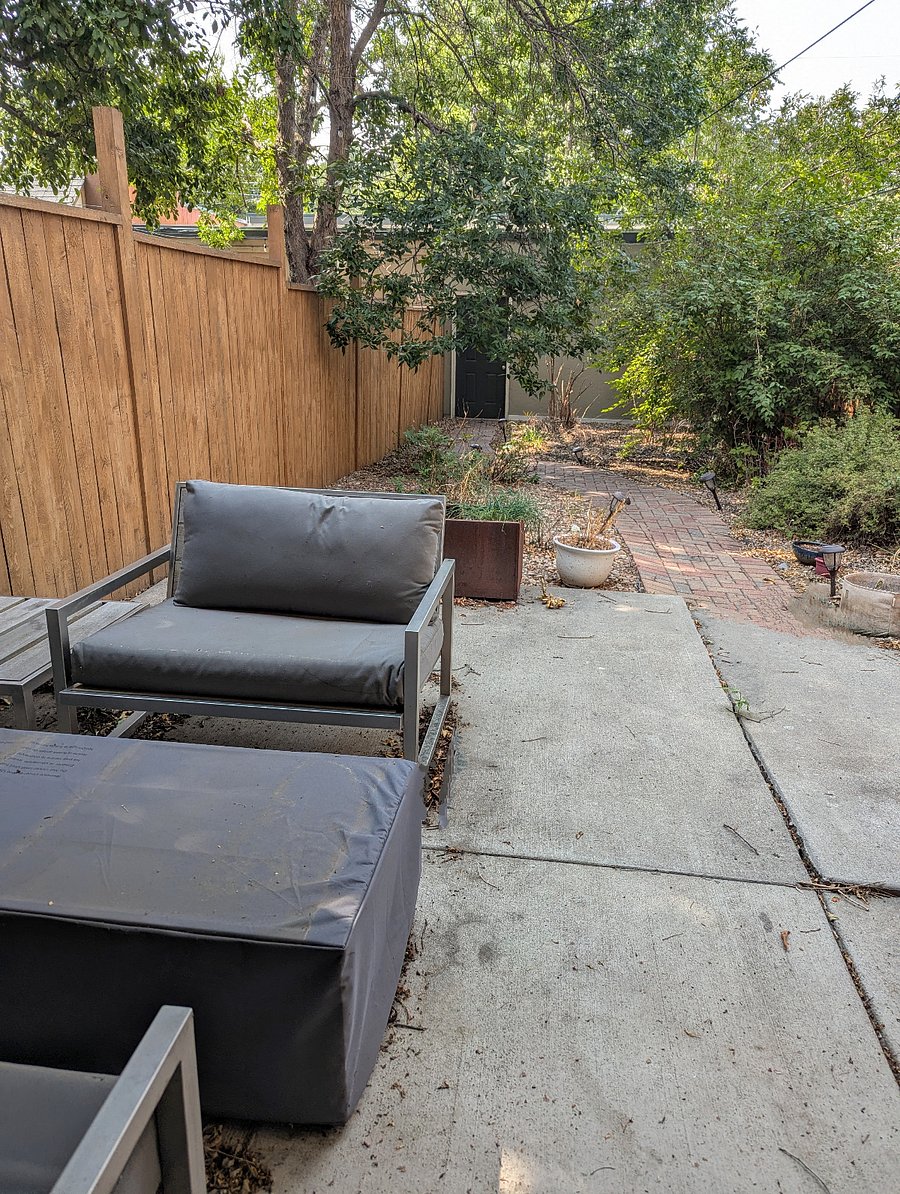 Patio with firepit and grill next to detached garage