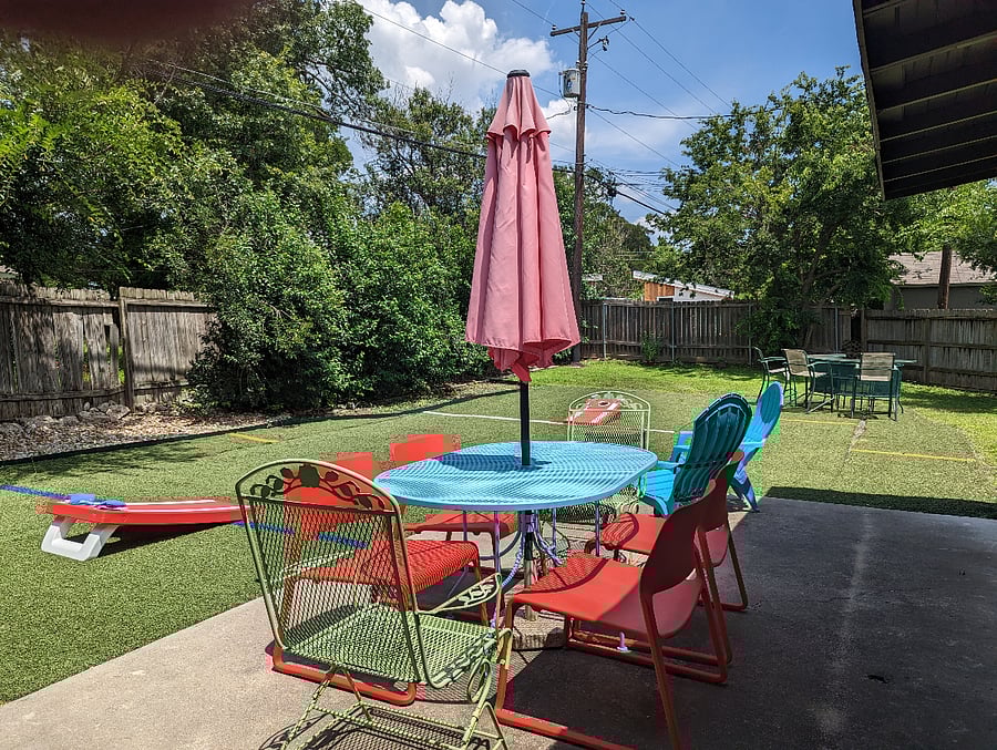 large fenced in back yard with patio