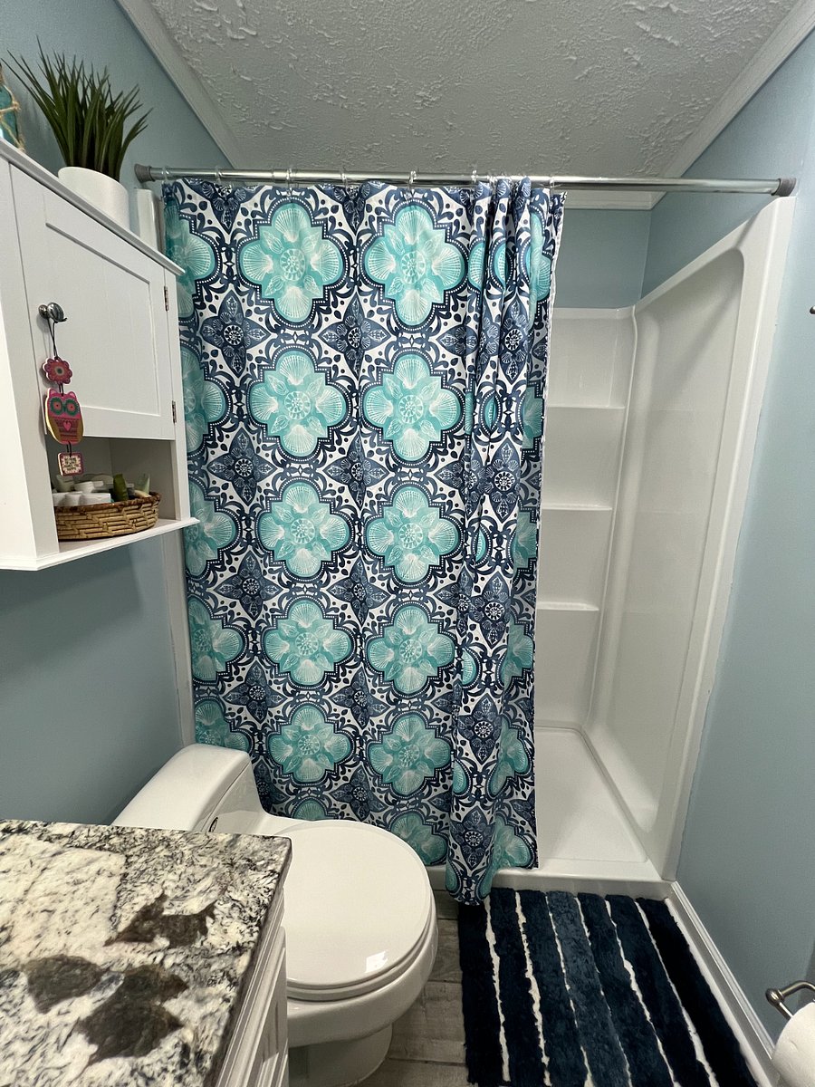 Walk-in shower with rain shower / handheld shower head combo.