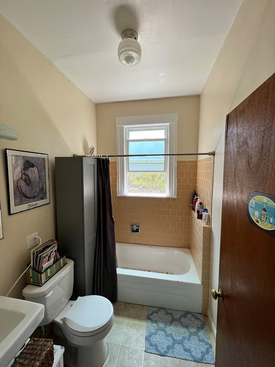 Well lit bathroom with bathtub