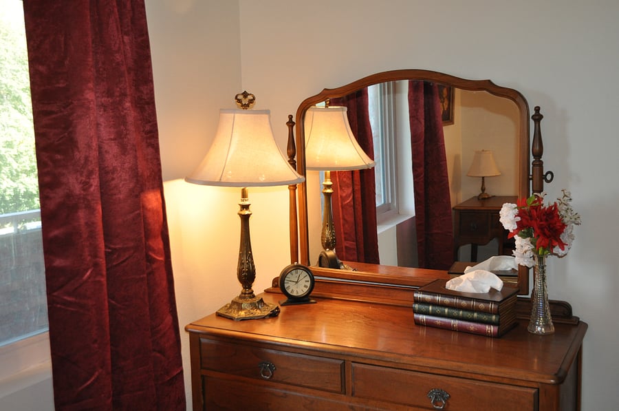 Matching antique dresser and desk set go with the bed.