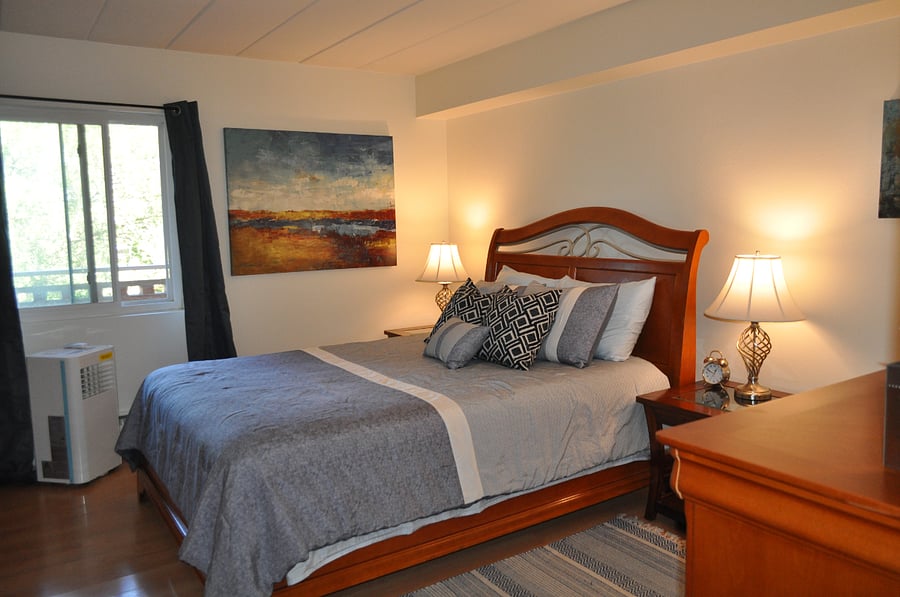 The master bedroom enters from the end of the hall, and features a Queen bed.