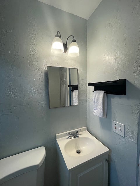 Bathroom with medicine cabinet and shelf.