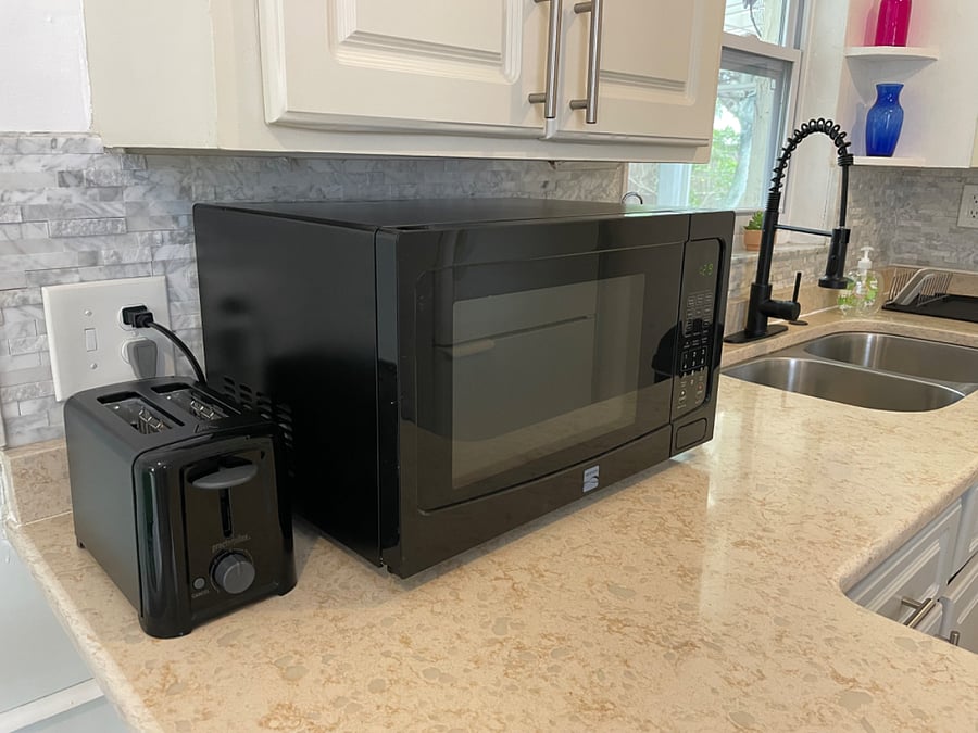 Kitchen counter with microwave and toaster.
