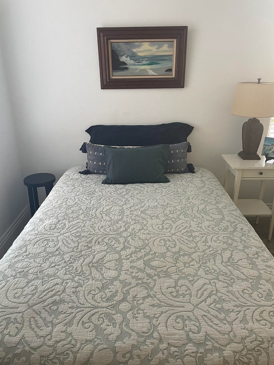 The black stool to the left of the bed is convenient for books, a cell phone, or a drink!