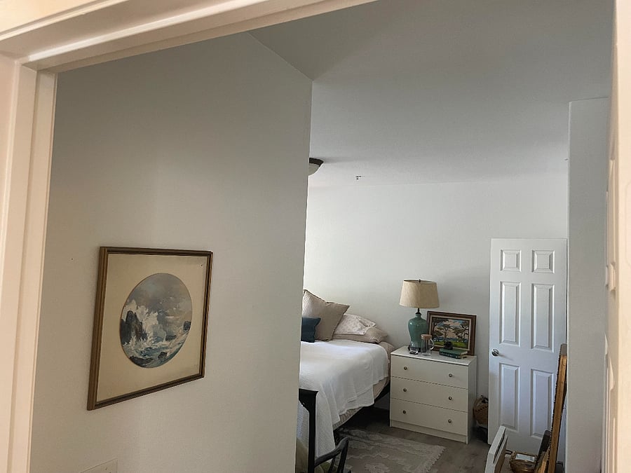 Entering the primary bedroom to the left of the laundry.