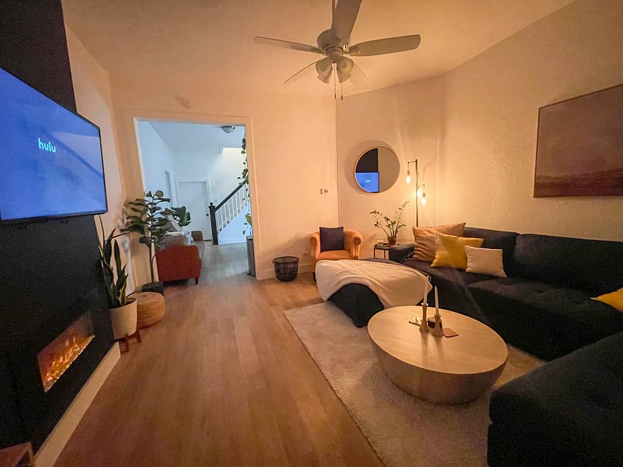 Oversized sectional couch with Roku TV and an electric fireplace. 