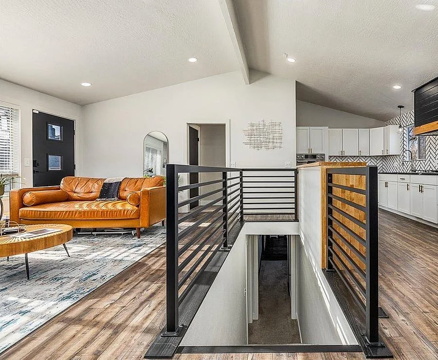 Stairs down to the king room, theatre/entertainment area, washer and dryer.