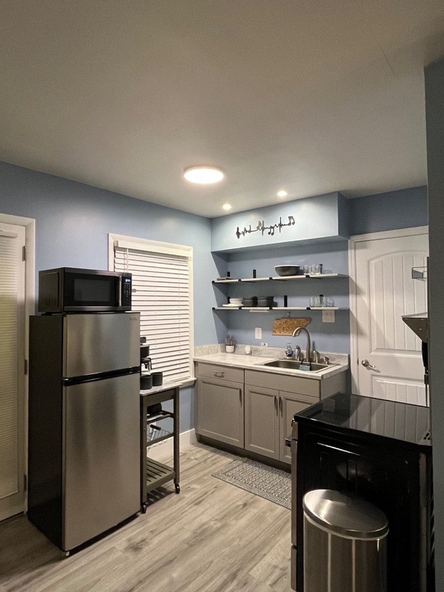 A kitchenette that features a refrigerator, 4 burner stove with oven, microwave, coffee/tea maker, a full sized sink, and a spacious pantry.  