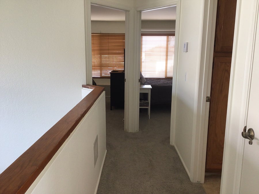 View of 2 bedrooms from top of stairs