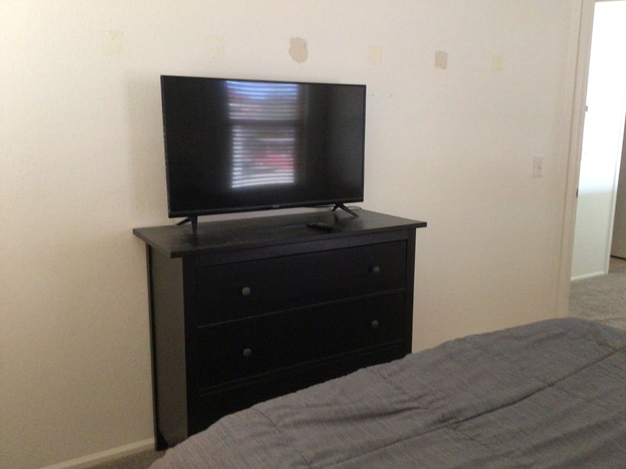 Bedroom on left. Queen bed, nightstand, dresser, tv, closet