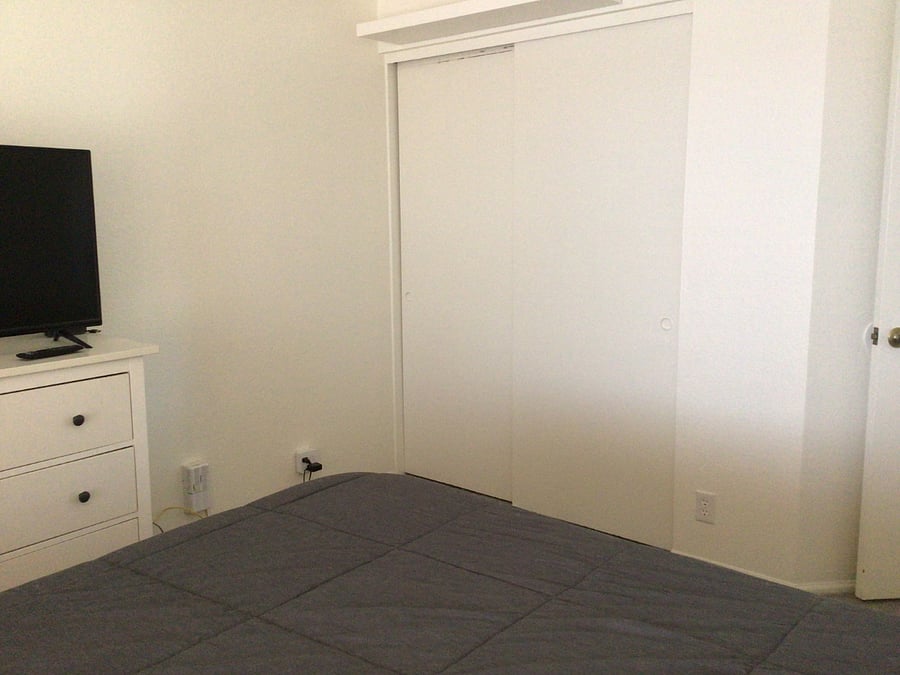 Bedroom on right. Queen bed, nightstand, dresser, tv closet