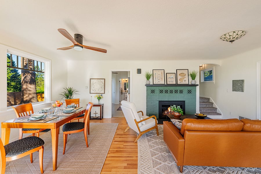 Great room with dining for six, comfortable couch and chair, with a state of the art gas fireplace