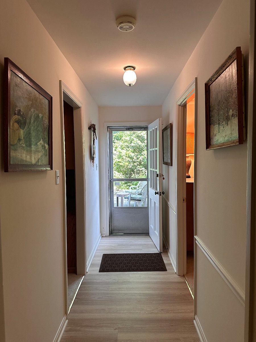 Hallway between family room entry through door on left and rental bedroom entry through door on right.