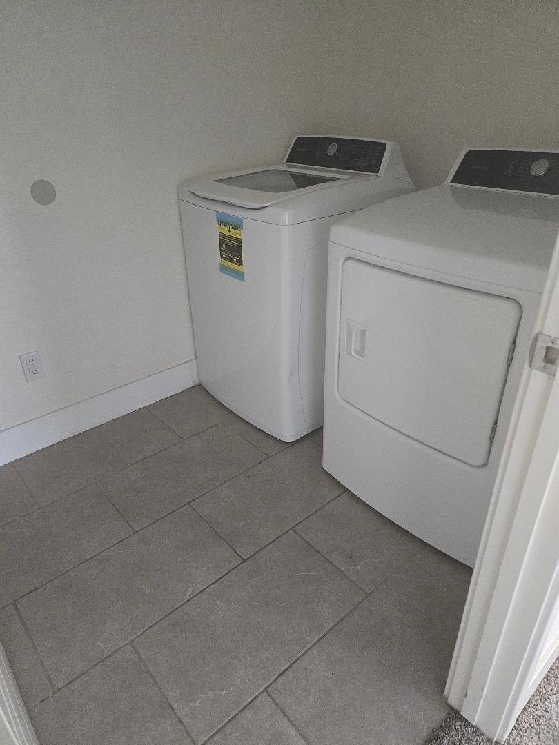 Laundry room with spacious shelves.