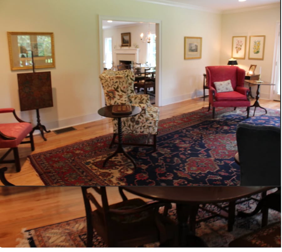 Large living room off kitchen w/ french doors facing east, large window facing south, with views of pasture.