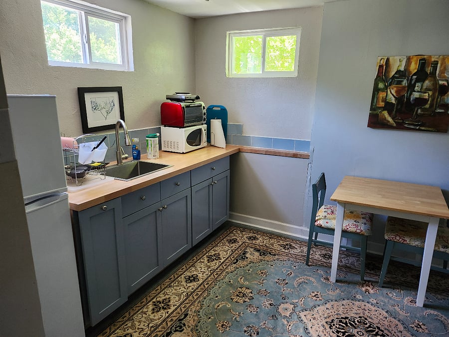 Kitchenette includes a fridge, sink, microwave, toaster oven, hot water boiler, coffeemaker, and two burner hot plate