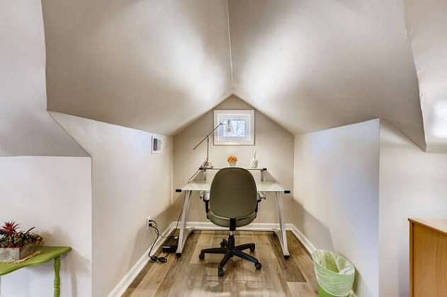 An alcove off the kitchen has a desk, chair, desk lamp and UPS power.