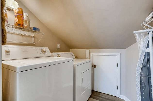 The laundry room with full size washer and dryer plus storage, hanging area and broom/mop storage along with starter supplies.