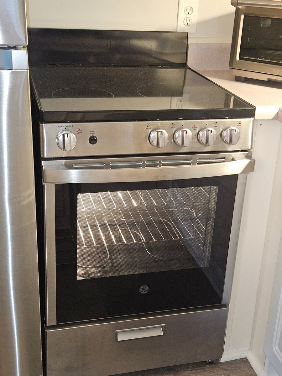 Conventional oven with smooth-top cooking surface.